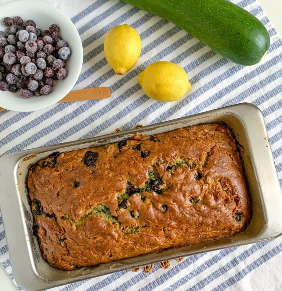 A loaf of baked blueberry zucchini bread in the loaf pan