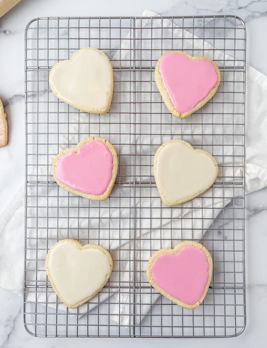 Iced almond flour shortbread cookies on a cooling rack