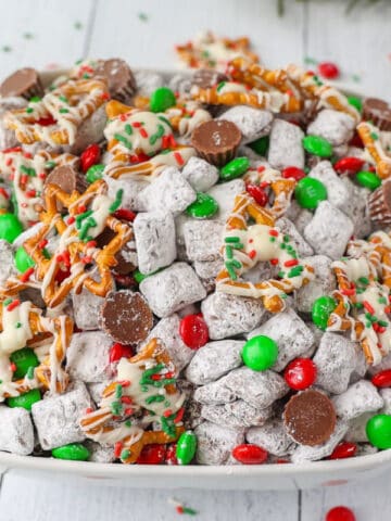 An overhead photo of Christmas Puppy Chow in a white bowl.