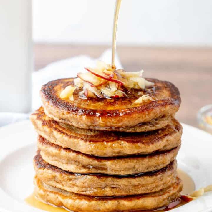 a stack of pancakes with syrup drizzled on top