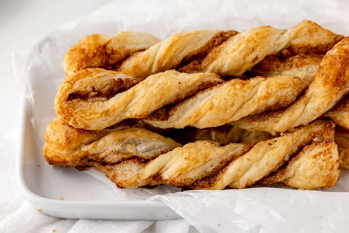 Cinnamon puff pastry twists on a white platter
