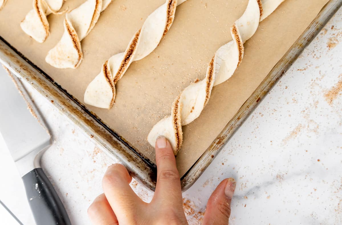 Flatten the ends of the twists to the sheet pan.