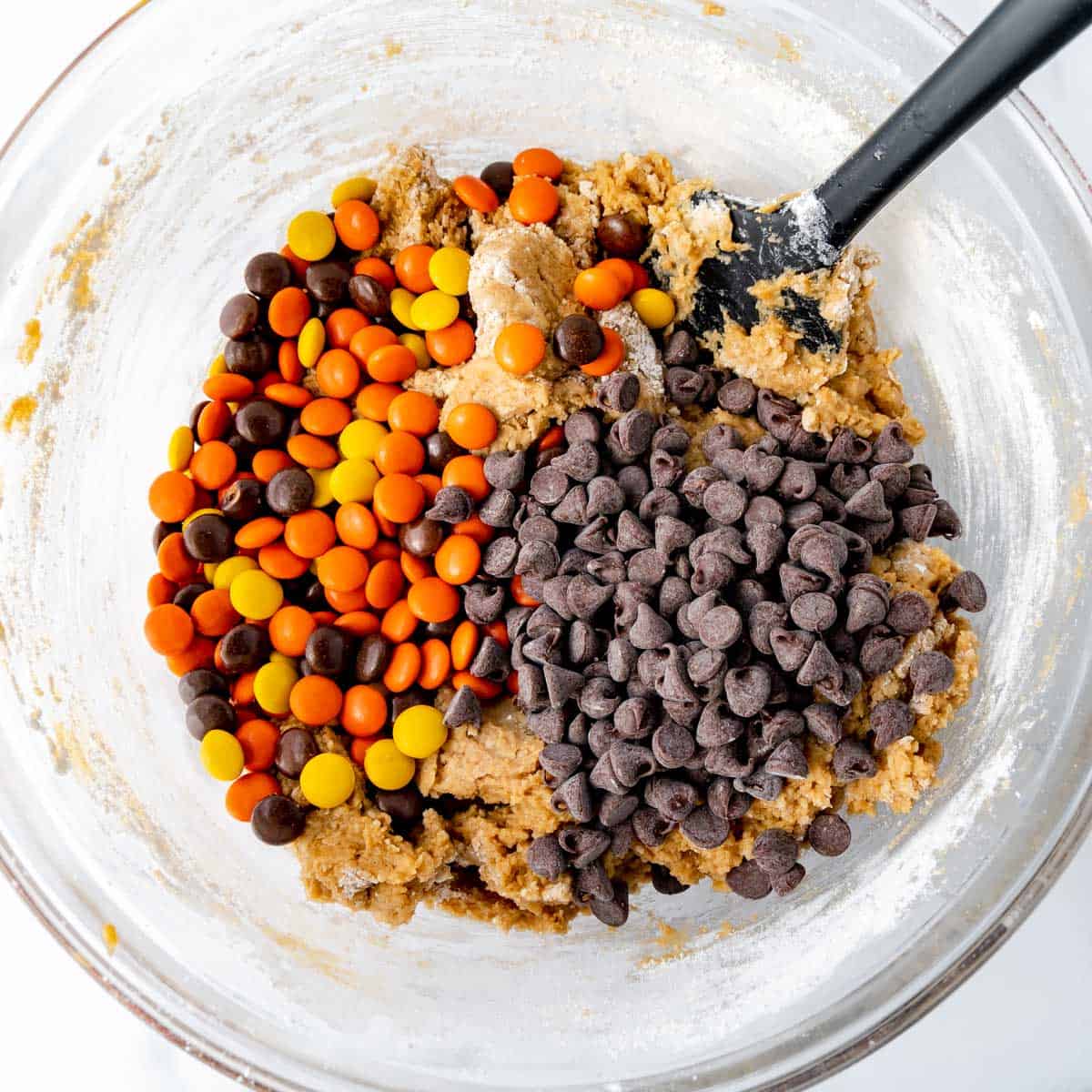 Chocolate chips and Reese's Pieces candy added to the peanut butter cookie dough