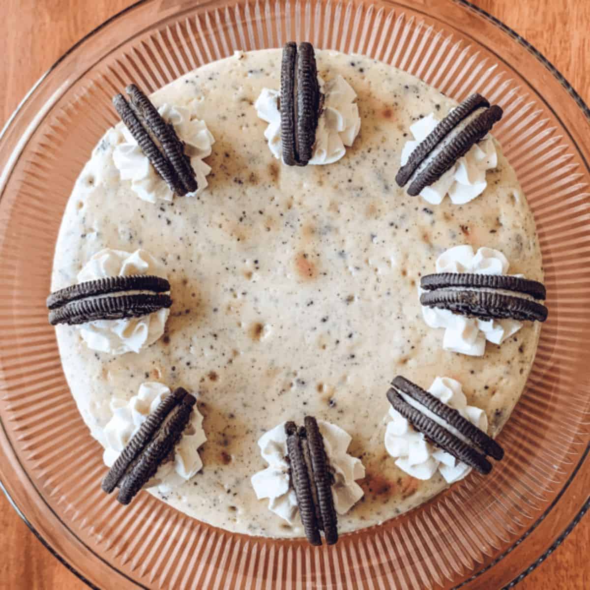 top view of cookies and cream cheesecake on a cake stand