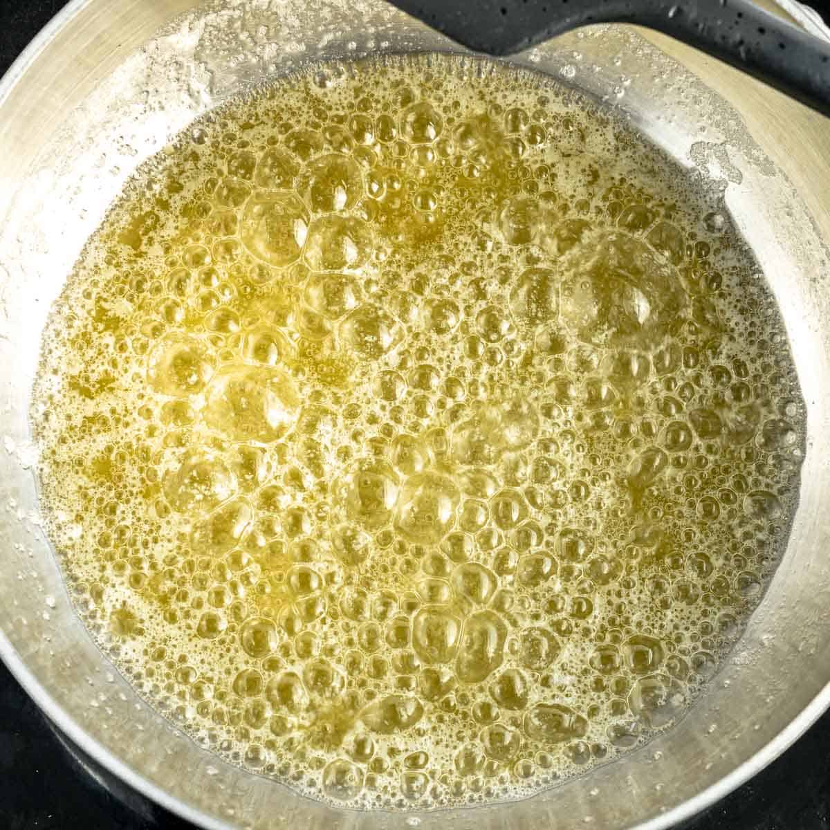 Butter melted and bubbling in a sauce pan.