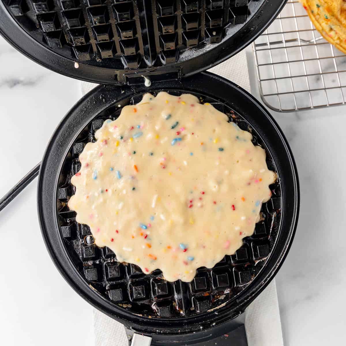 Waffle batter in a waffle iron