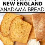 Sliced Anadama Bread on a wooden cutting board with a loaf, a dish of butter, and a jar of jam nearby.