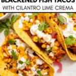 Three corn tortillas filled with savory blackened fish, corn, cilantro, pickled onions, and lime crema—these Blackened Fish Tacos are arranged on a white surface with a partial view of a sauce bowl.