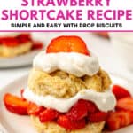 A plate with a Classic Strawberry Shortcake made of biscuits, whipped cream, and sliced strawberries. Text above reads: “Homemade Strawberry Shortcake Recipe. Simple and easy with drop biscuits.”.